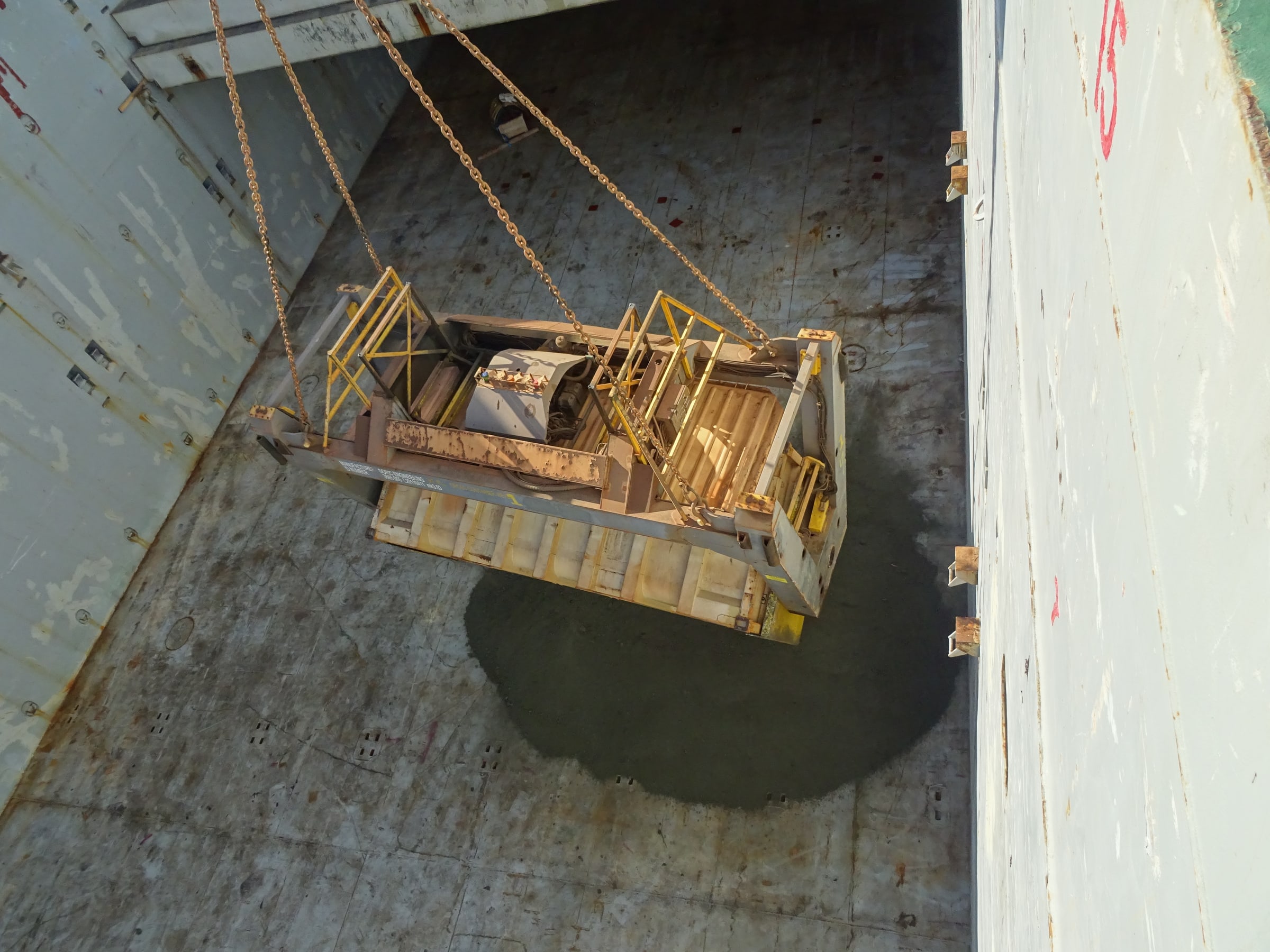 Cargo-handling equipment being positioned inside a vessel hold at Port Hedland