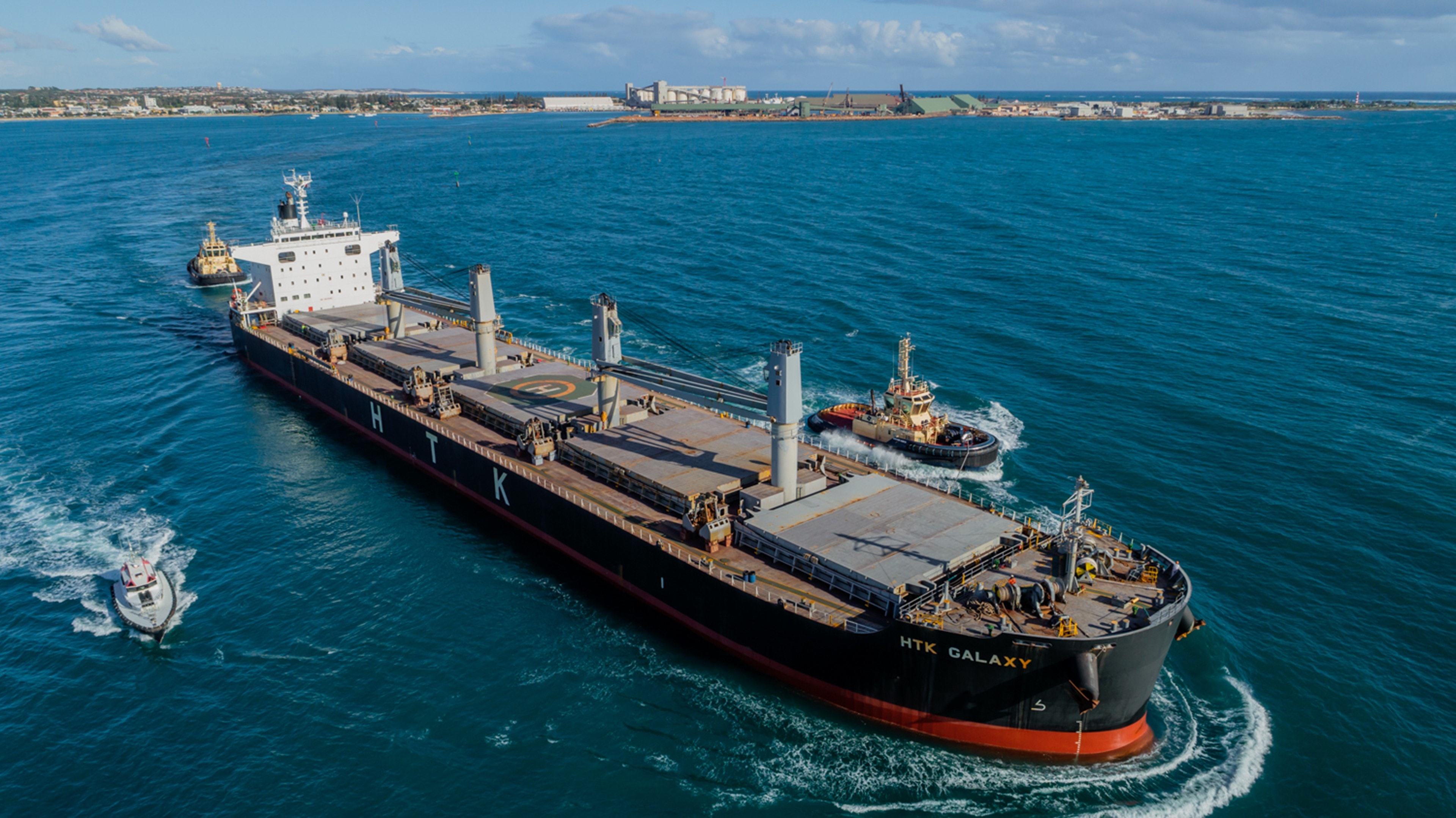 Bulk carrier HTK Galaxy guided by tugboats toward Geraldton Port