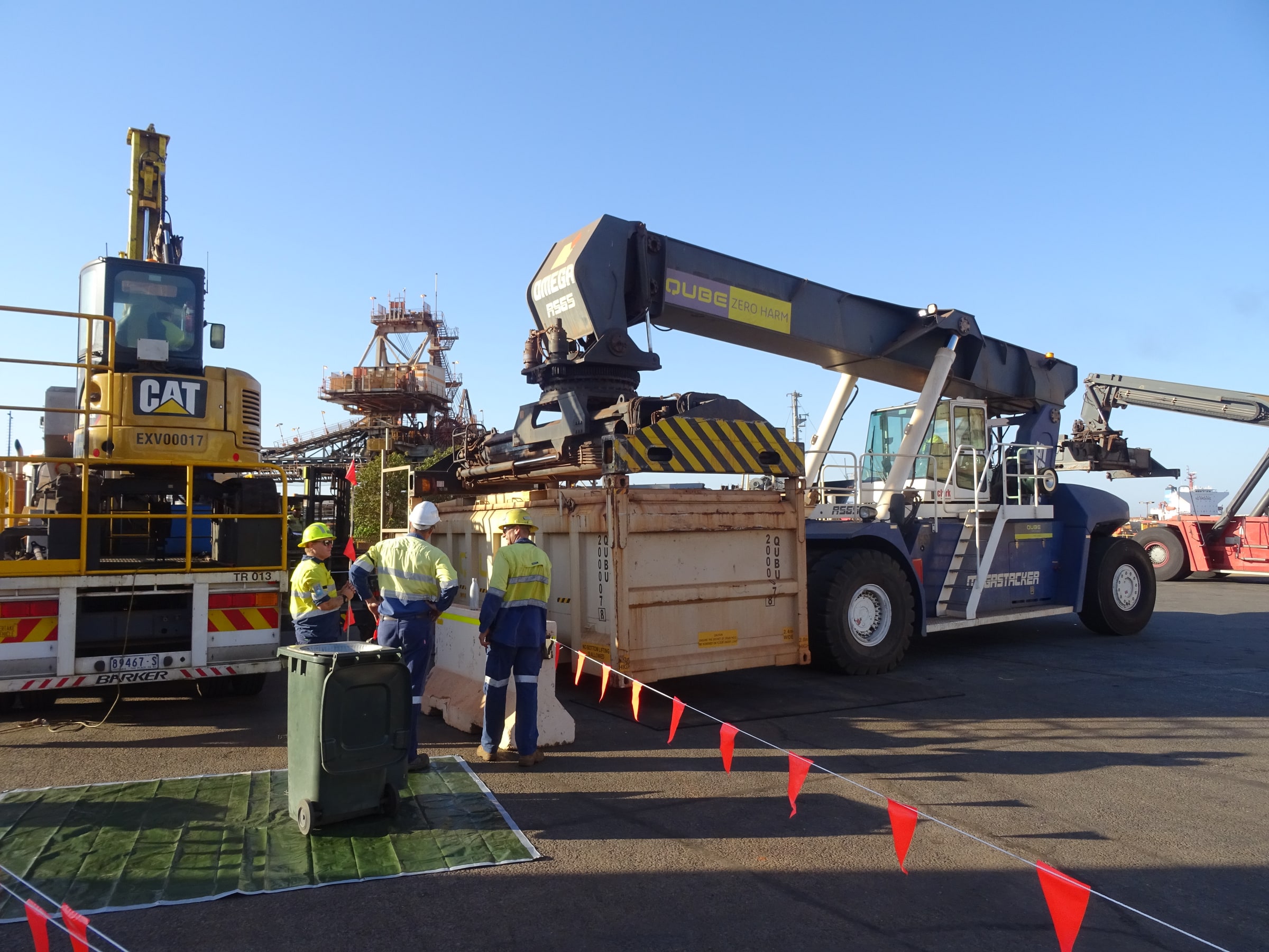 Field crew working beside cargo-handling equipment at Port Hedland
