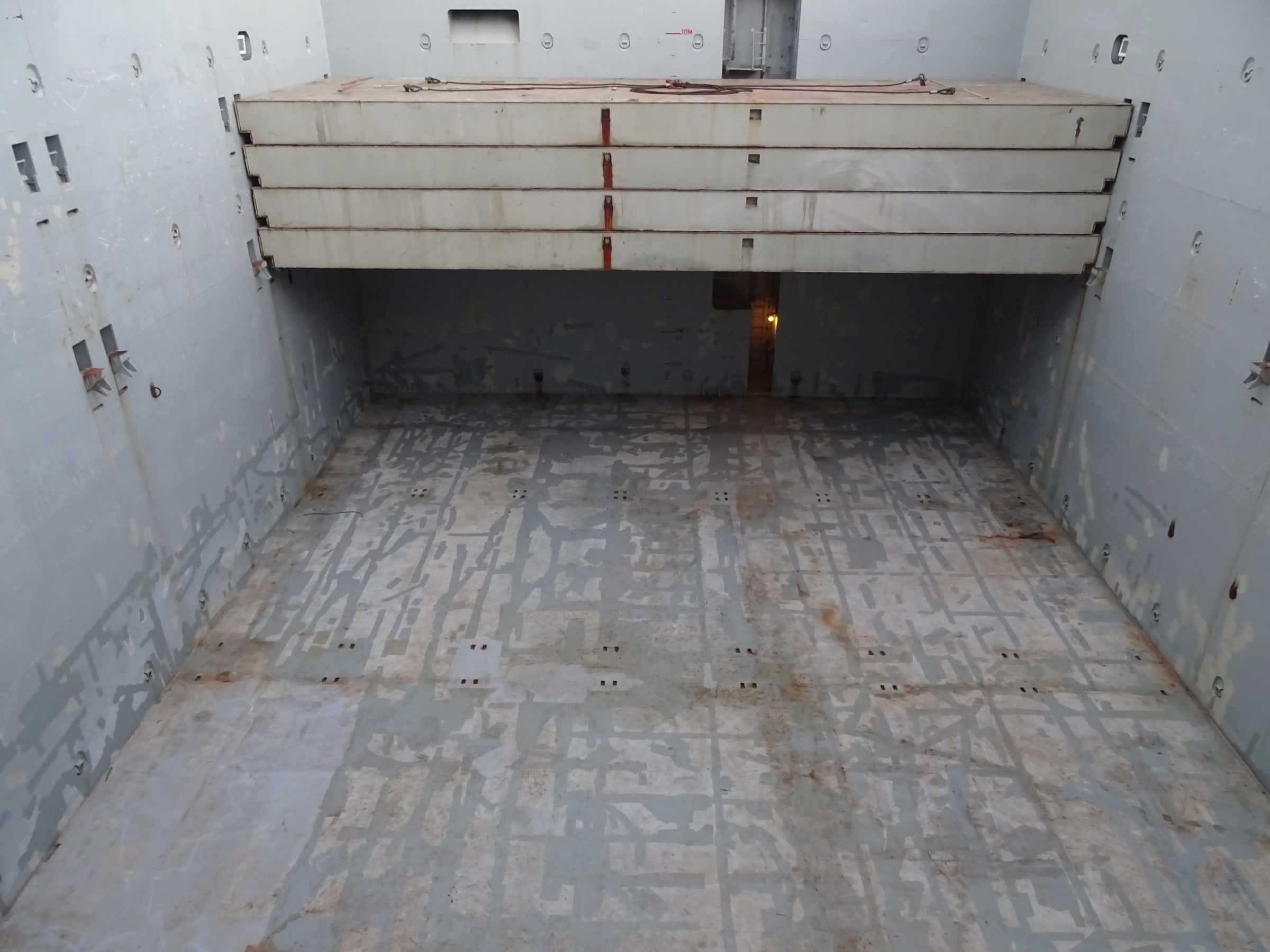View into an empty steel cargo hold inside a bulk carrier at Port Hedland