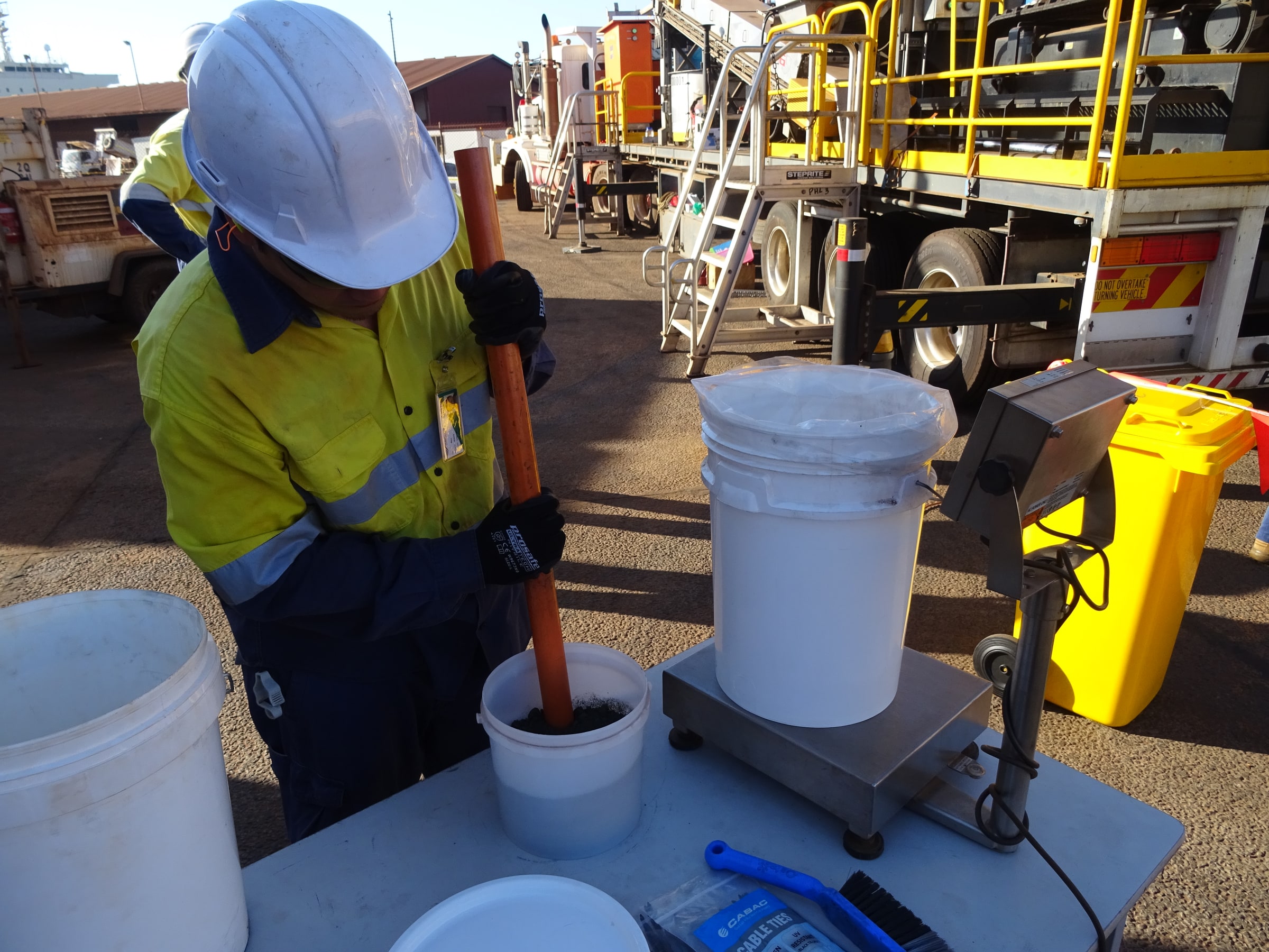 Worker preparing a bulk cargo sample at Port Hedland
